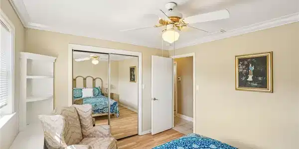 Image 2: Bedroom with crown molding, a ceiling fan, light wood-style floors, and a closet