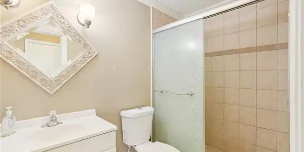 Image 3: Full bath with vanity, a stall shower, and ornamental molding