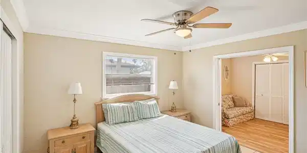 Image 4: Bedroom featuring a closet, light tile patterned floors, ceiling fan, and ornamental molding