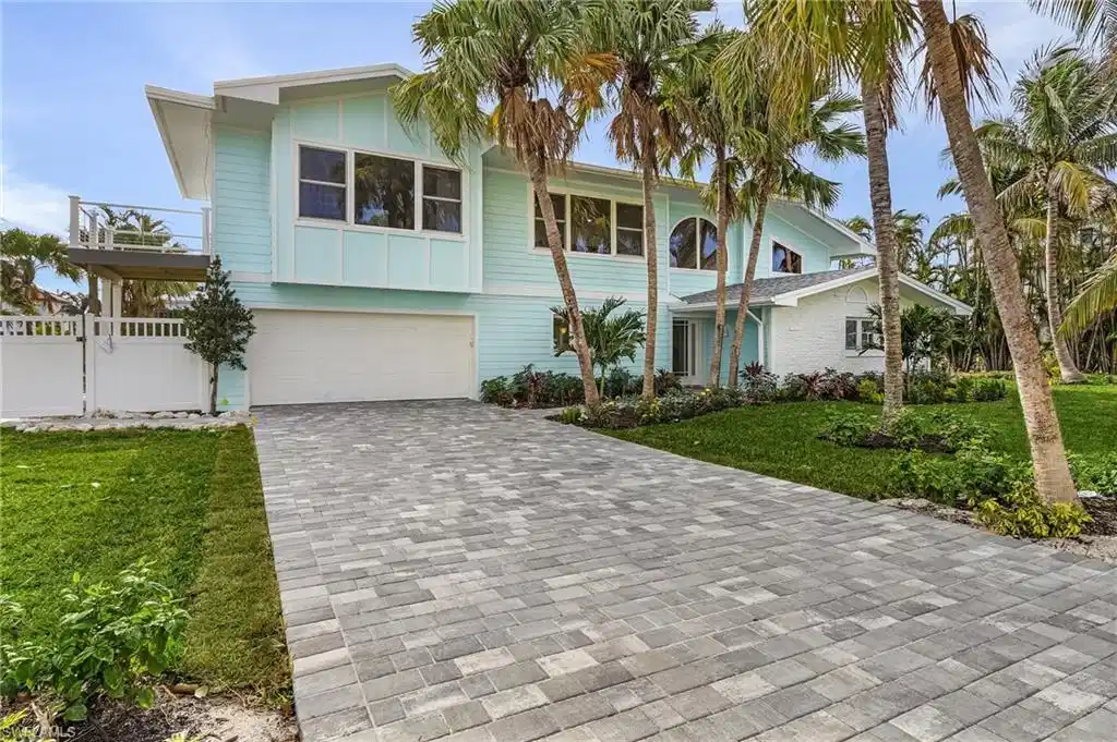 Image 1: View of front facade with decorative driveway and an attached garage