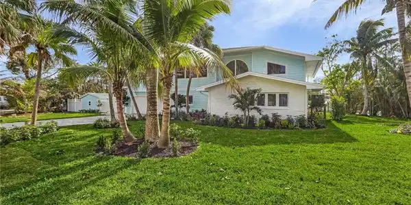Image 2: View of front of house featuring a front lawn