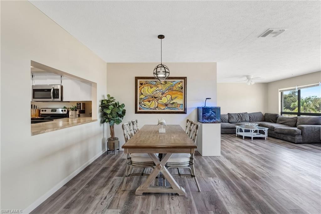 Image 1: The living area is bright, welcoming, and perfectly positioned to enjoy the waterfront setting.