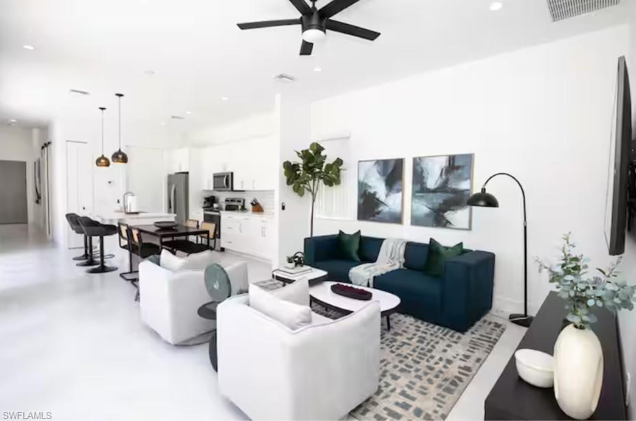 Image 4: Open-concept living space, kitchen and dining area