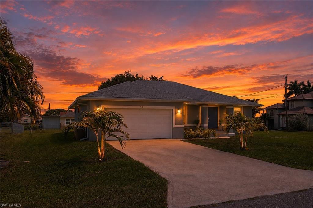 Image 2: Single-story residence featuring a neutral exterior, attached garage, and concrete driveway
