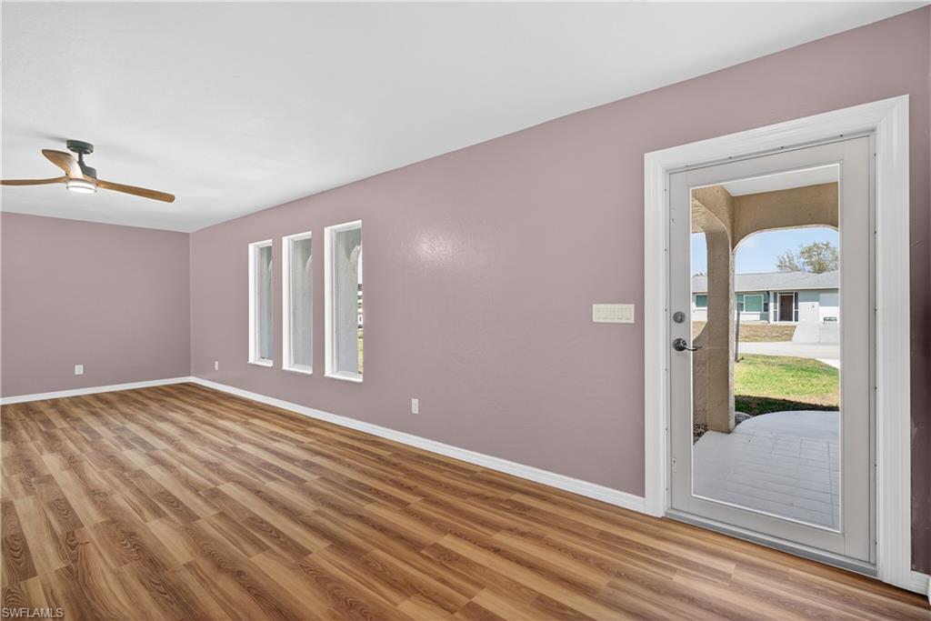 Image 2: Front Living Room off entry featuring  ceiling fan, light wood finished floors, and plenty of natural light