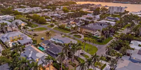 Image 2: Neighborhood setting with numerous residential properties, mature palm trees, and established landscaping