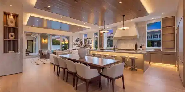 Image 4: Wood-finish flooring throughout, recessed lighting, and a wood-paneled ceiling with accent lighting
