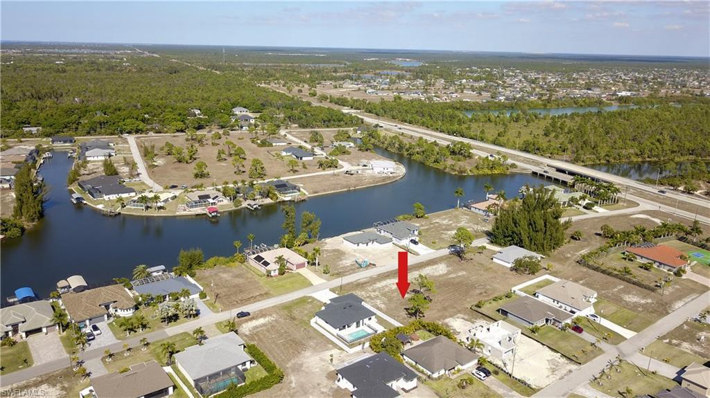 Image 4: Aerial overview of property's location featuring nearby suburban area and a newaterarby body of