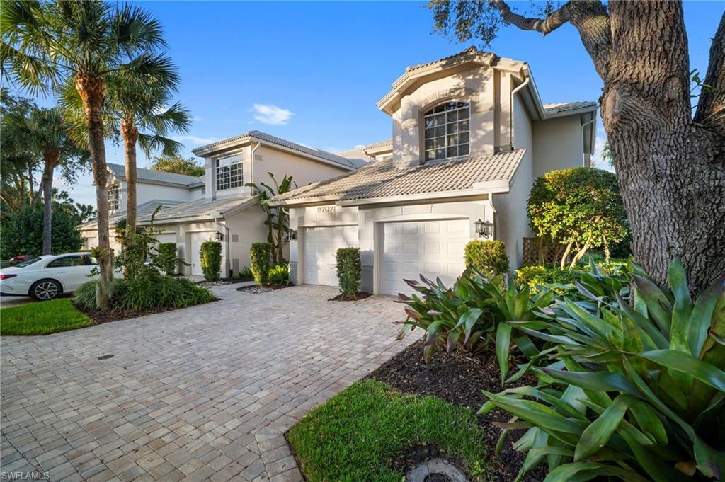 Image 2: Mediterranean home with stucco siding, a tile roof, decorative driveway, and an attached garage