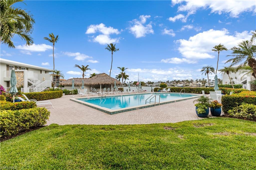 Image 2: Community pool located on the bayside.  Cabana and docks in background near the bay.