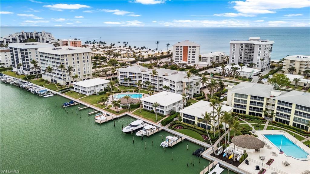 Image 3: View from bay showing community pool, docks. Quick Gulf access through Doctor's Pass by Admiralty Point Condos, top left of photo.