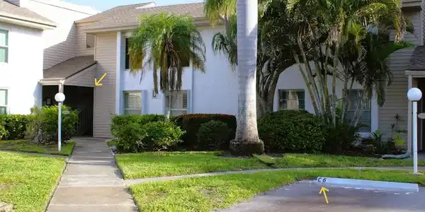 Image 2: View of front of house featuring stucco siding, uncovered parking, and a front yard