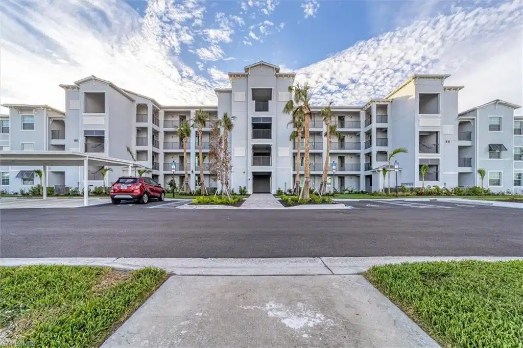 Image 1: View of apartment building / complex with uncovered parking