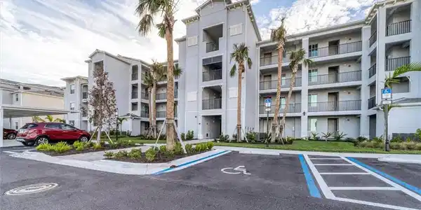 Image 2: View of apartment building / complex featuring uncovered parking
