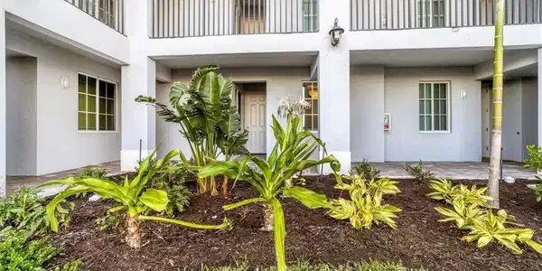 Image 3: Property entrance featuring stucco siding