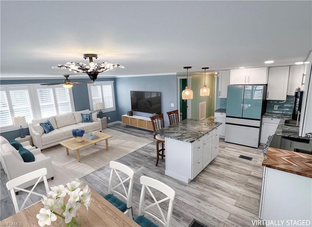 Image 3: Virtual staged dining, living and kitchen areas