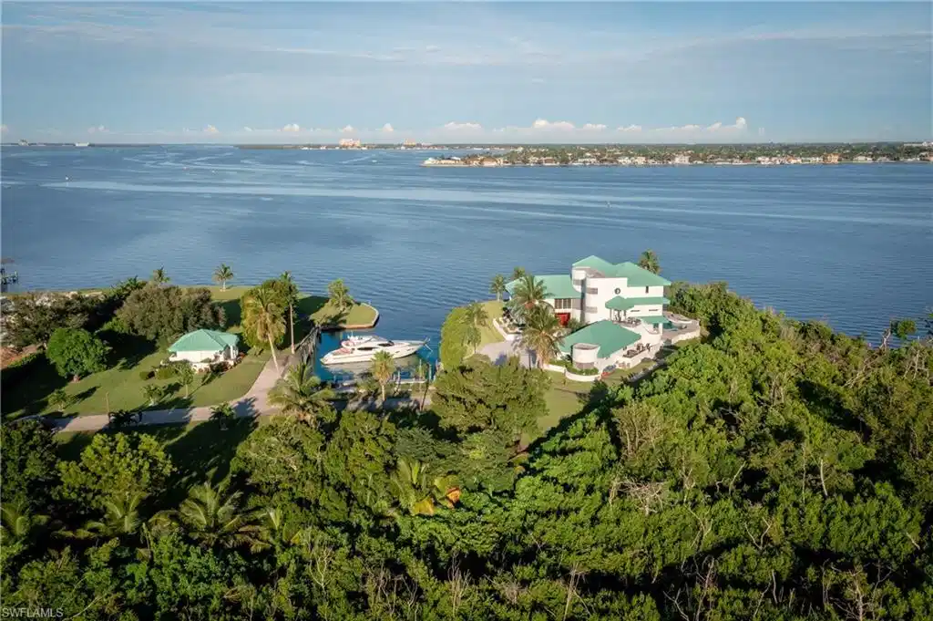 Image 1: Aerial view of property and surrounding area with a large body of water