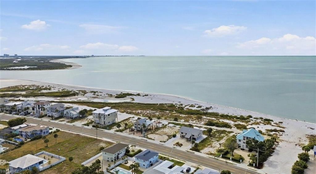 Image 4: Aerial perspective of suburban area featuring a large body of water