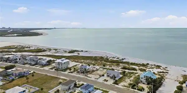 Image 4: Aerial perspective of suburban area featuring a large body of water