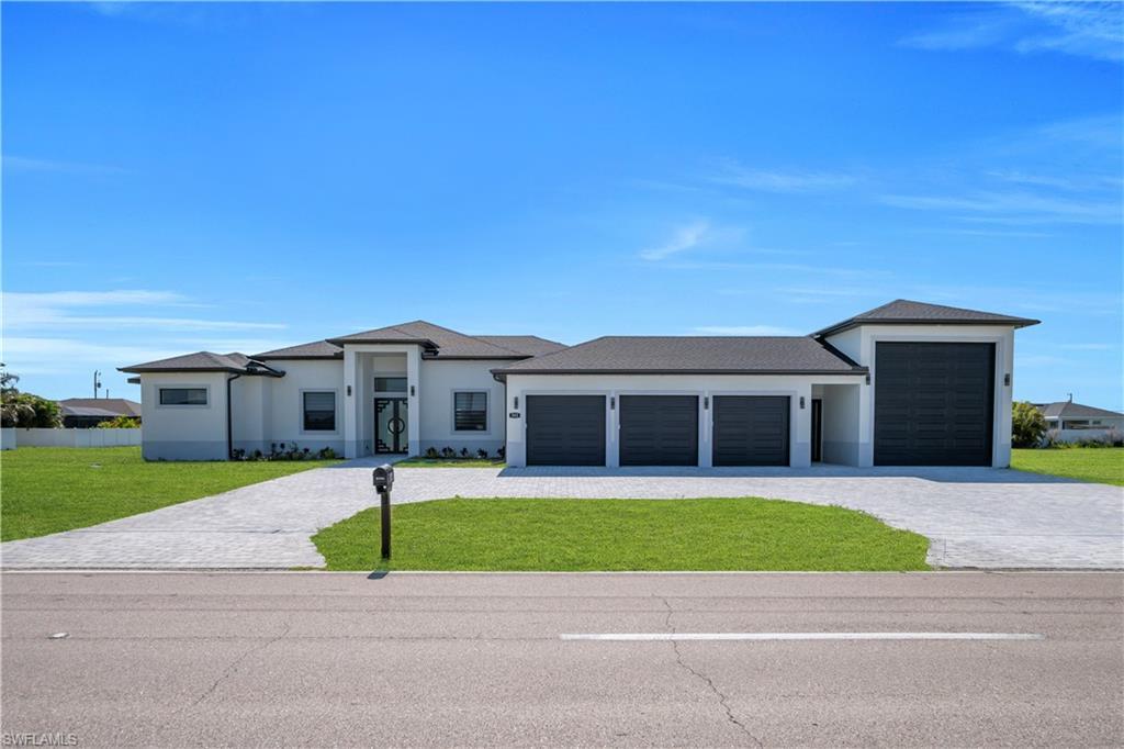 Image 2: Contemporary stucco exterior with a dark shingle roof and contrasting dark garage doors