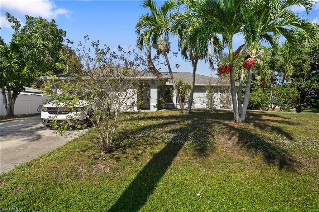 Image 4: Ranch-style house with a front lawn