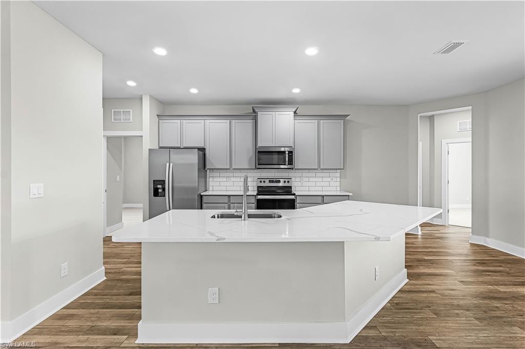 Image 3: Entryway with dark wood-type flooring and plenty of natural light