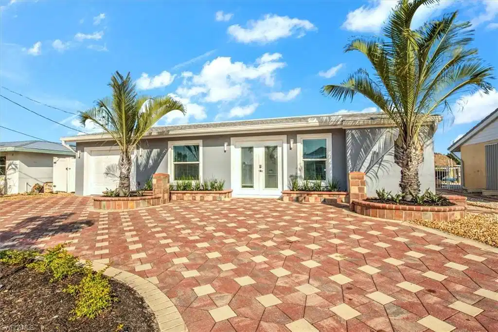Image 1: View of front of property featuring french doors and a garage
