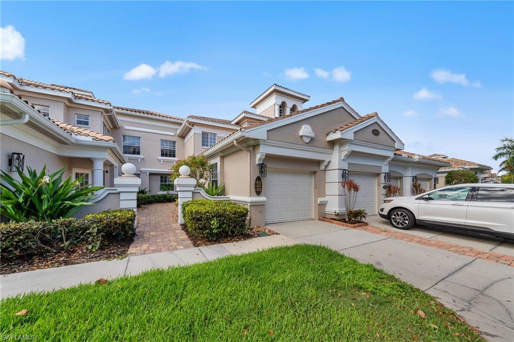 Image 1: Mediterranean / spanish-style house with stucco siding, driveway, a tile roof, a garage, and a front lawn
