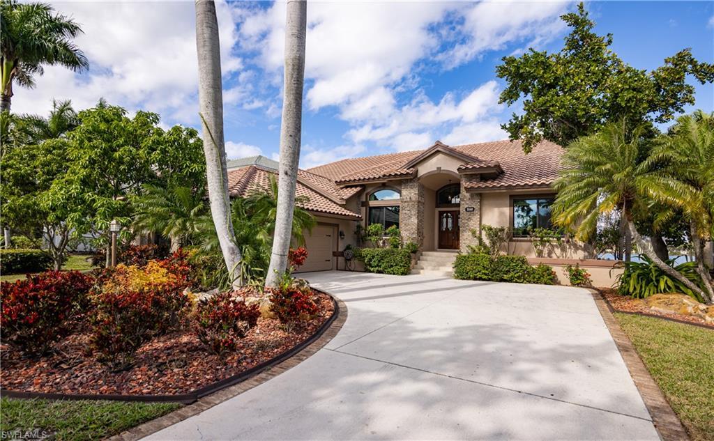Image 3: Mediterranean-style residence featuring a tile roof, stucco exterior, and stone facade accents