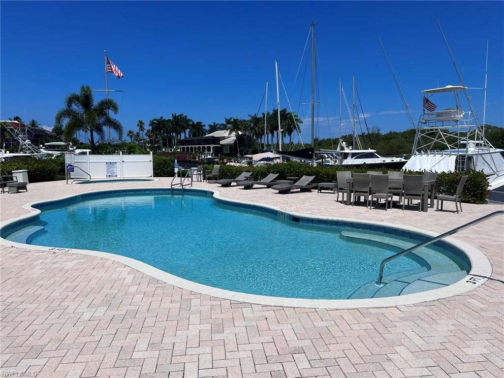 Image 4: Freeform swimming pool surrounded by a paver deck