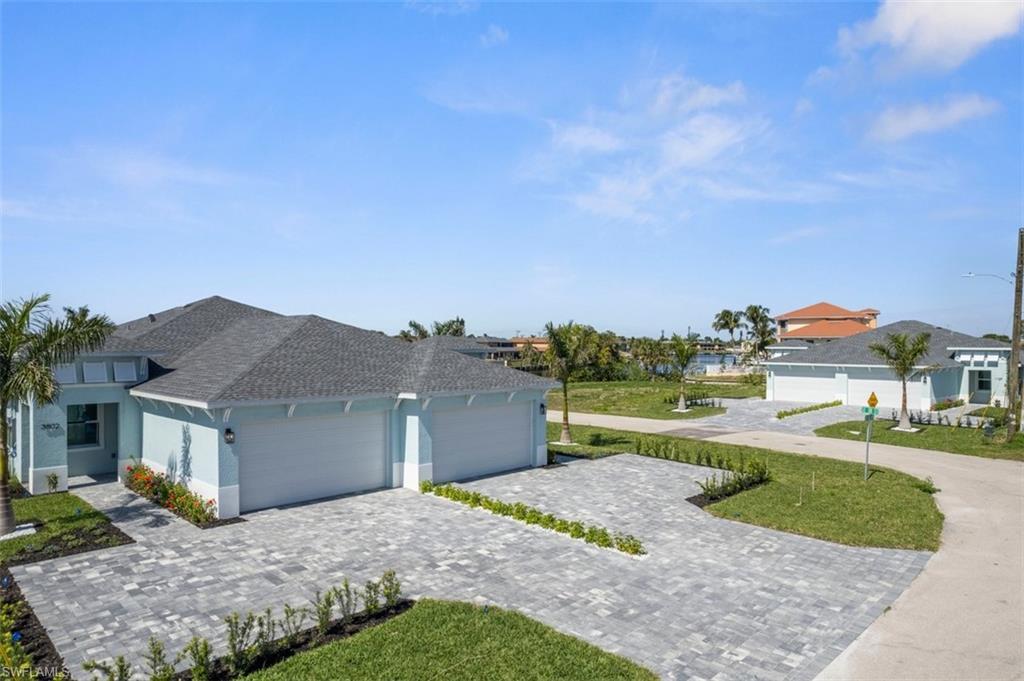 Image 2: Single story home with a shingled roof, decorative driveway, an attached garage, and stucco siding