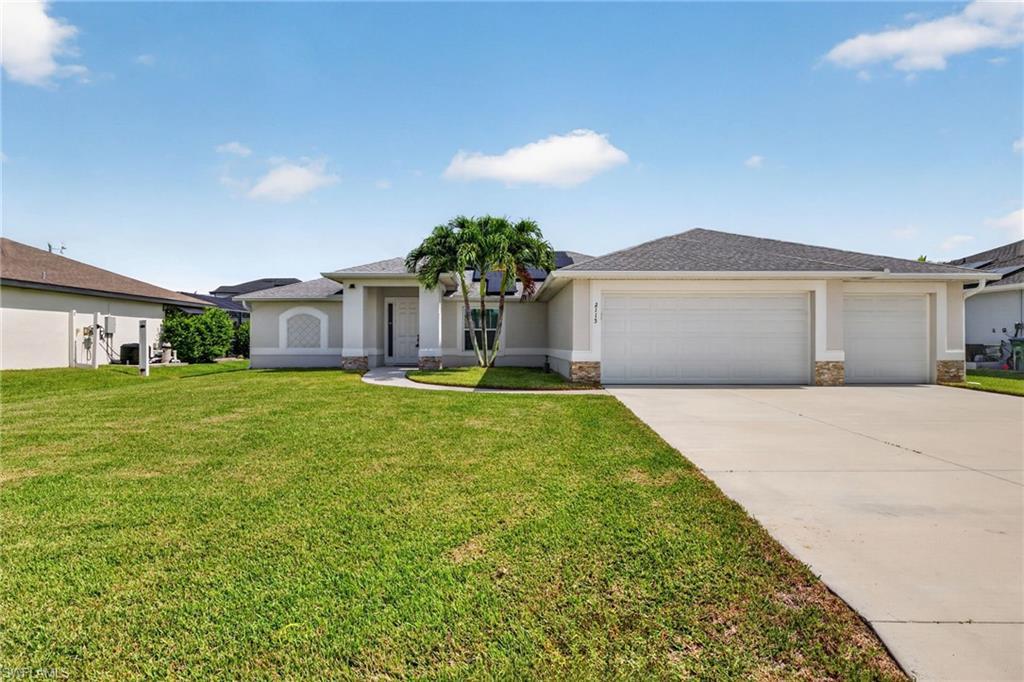 Image 1: Ranch-style exterior with a three-car garage, concrete driveway, and a front lawn