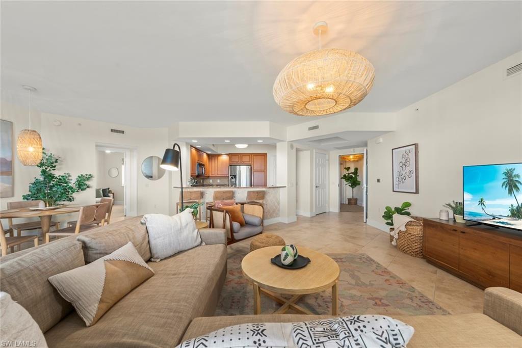 Image 2: Living room featuring light tile patterned floors and recessed lighting