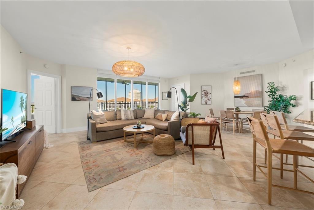 Image 3: Living area featuring baseboards and light tile patterned flooring