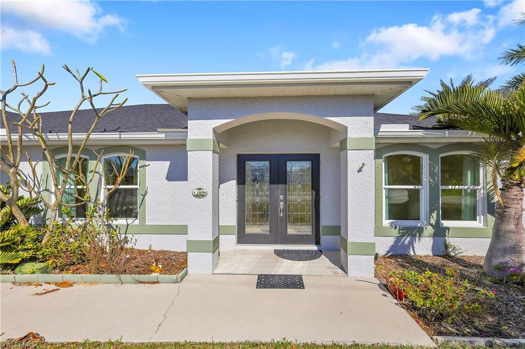 Image 1: Doorway to property with stucco siding, a shingled roof, and french doors
