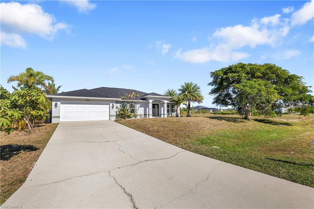 Image 2: Ranch-style house featuring a front lawn, concrete driveway, and an attached garage
