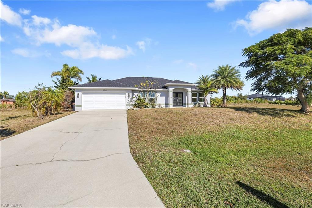 Image 4: Ranch-style house with a front lawn, driveway, and an attached garage