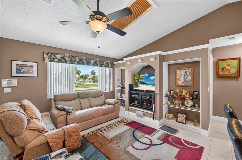 Image 3: Vaulted ceiling with a central ceiling fan and light fixture