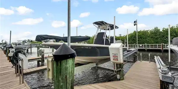 Image 4: Boat slip #18 offers a 10,000# lift. Slip #18 is assigned to the seller and can accomodate a 28' vessel.