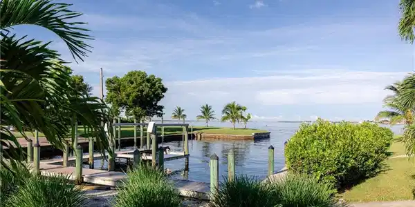 Image 3: Dock featuring boat lift and a water view