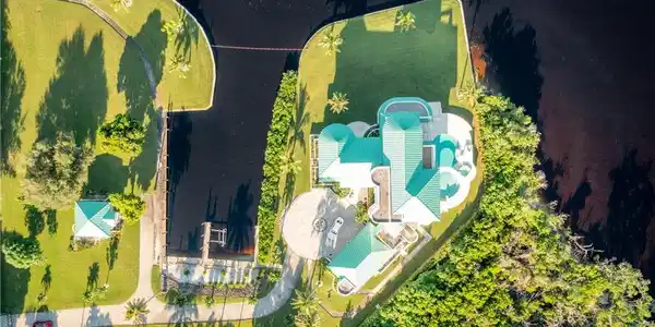 Image 4: View from above of property with a pool