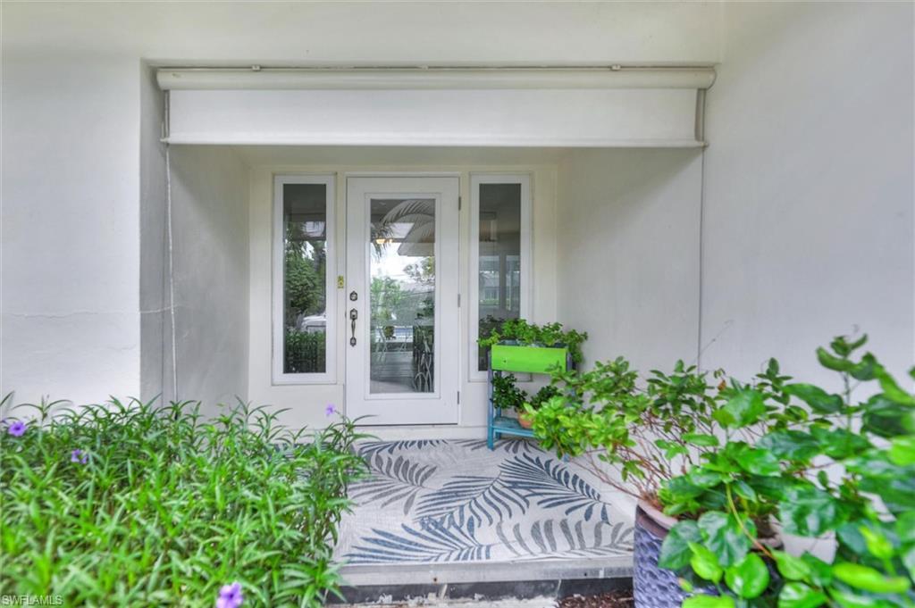 Image 3: Property entrance featuring stucco siding