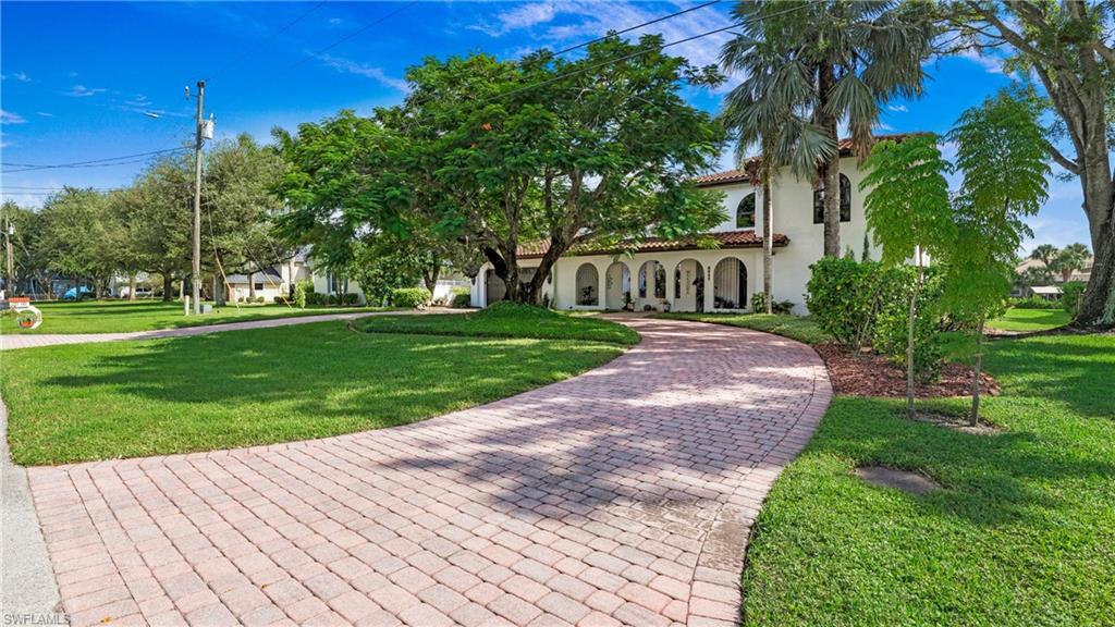 Image 2: Mediterranean / spanish-style home with a front lawn, stucco siding, and a tiled roof
