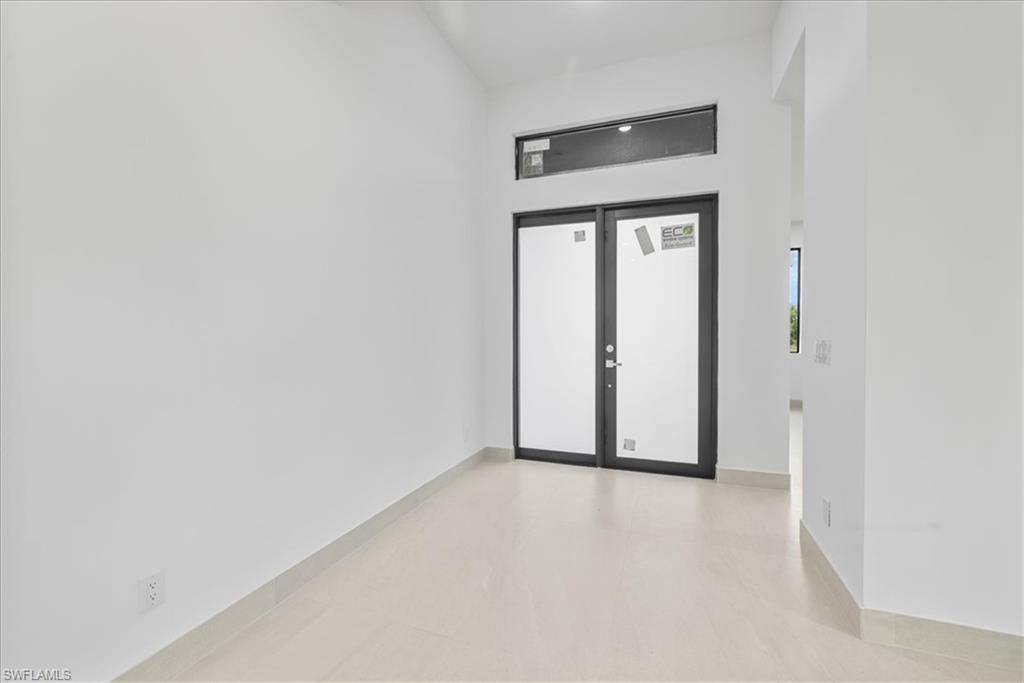 Image 3: Doorway to property with stucco siding and french doors