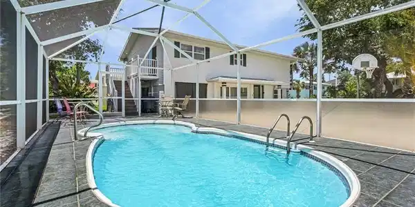 Image 4: View of swimming pool with a lanai and a patio area