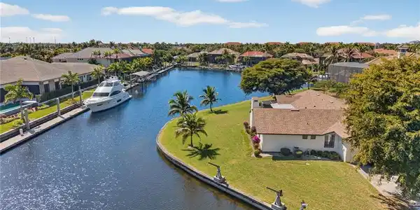 Image 2: Aerial view of residential area featuring a large body of water