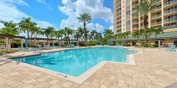 Image 3: Community pool featuring a patio