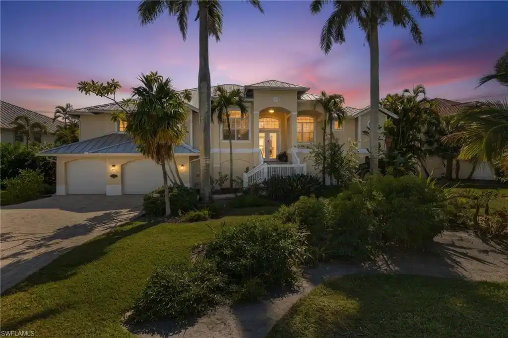 Image 1: Mediterranean / spanish-style house featuring decorative driveway, stucco siding, a standing seam roof, a metal roof, and a garage