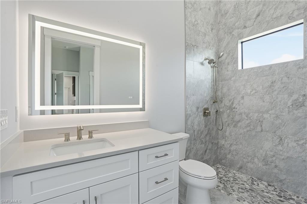 Image 2: Full bath with a tile shower and vanity