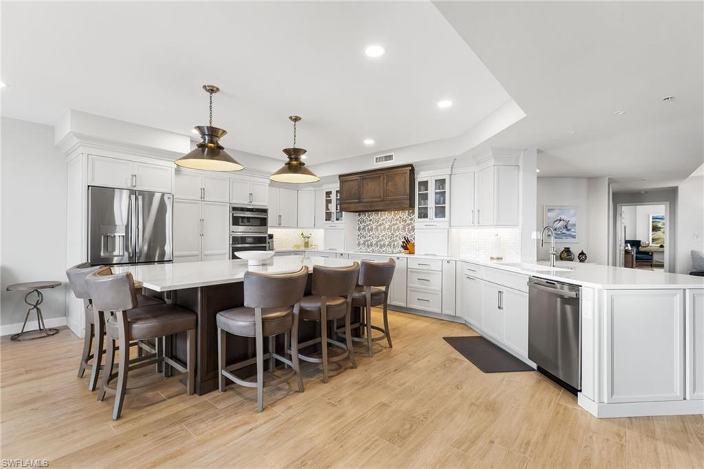 Image 3: Beautful backsplash, stainless steel appliances, custom cabinetry, underlighting.